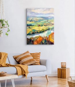 valley and river painting hanging above a couch as a design idea