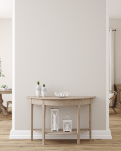 blank wall in neutral room with a console waiting for a painting to be hung