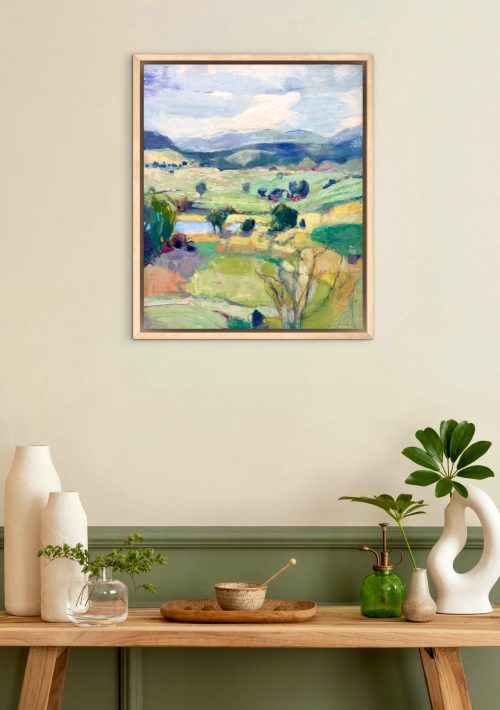 encaustic landscape painting hanging on a wall with decor to show collectors how to design their room